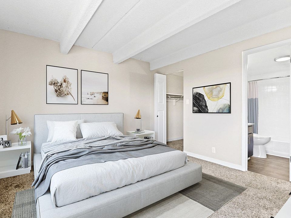 Bright and inviting bedroom with exposed beam ceiling and soft neutral palette