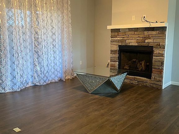 Living room with stone fireplace