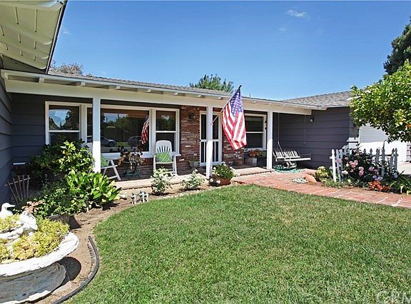 Sweet porch area, large picture window and brick path that leads to minimal steps into the house.