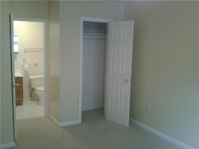 view of closet and private bath in Master bedroom