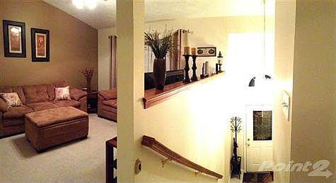 Second view of the upstairs living area, highlighting the beautiful ceramic tile entry and palladium window.