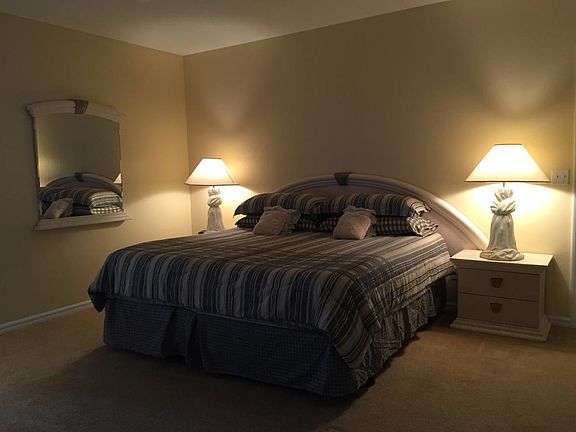 Master bedroom with king bed, TV, telephone, sitting area, l