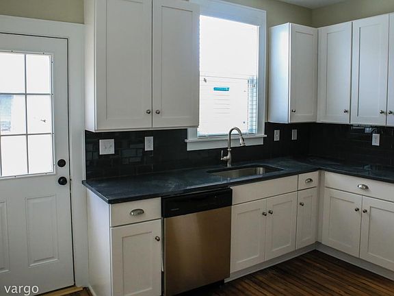 Remodeled kitchen with shaker style cabinets and granite