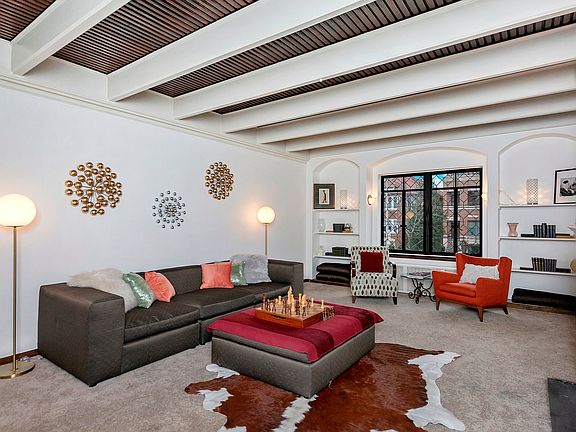 Features high beamed ceilings