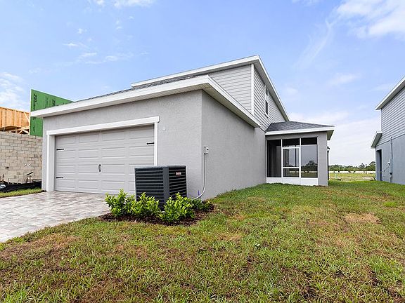 This home includes a rear-entry 2-car garage with a paver driveway.