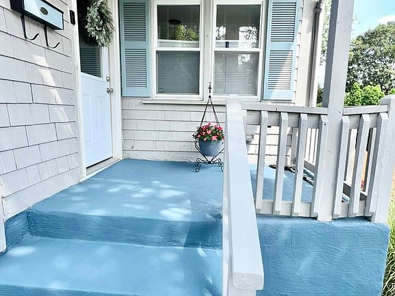 Front entrance to the home and cute little porch perfect for your plants or holiday decorations.