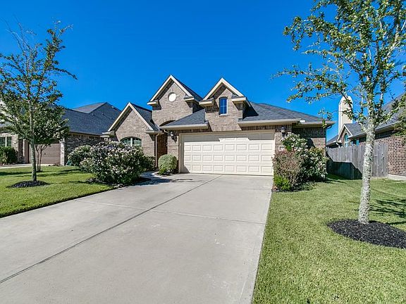 Another perspective of the large front yard with its  custom lush landscaping.