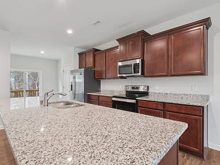 Classic Package Chef-inspired kitchen with stainless steel appliances and granite countertops