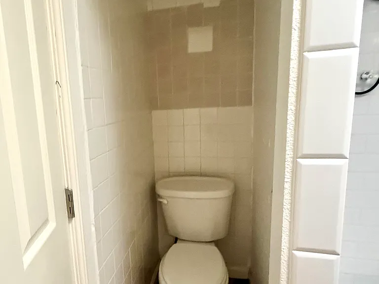 2nd BR - "WC" nook behind door to bathroom -- shower slightly visible to the right, door to entire bathroom visible on left.
