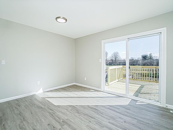The dining area and beautiful new sliding glass door that leads onto your newly resurfaced deck with stairs that lead down to the back yard.