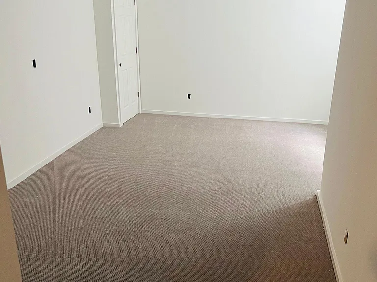20 x 12 bedroom with large window; original house beam, ceiling fan, new carpeting, large closet.