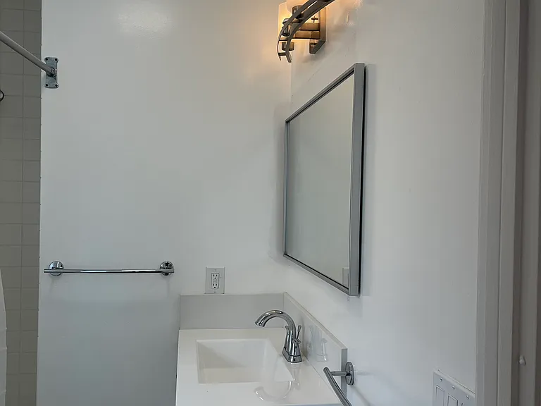 BATHROOM: NEW CABINET, SINK, PLUMBING FIXTURES AND LIGHTING