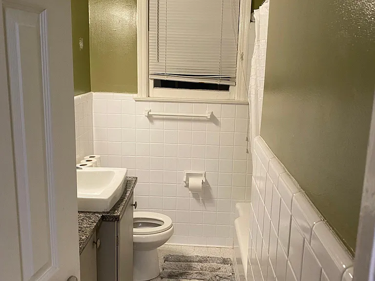 Bathroom view from Hallway. Unseen shower and tub on the right. Note the authentic Mid Century sink.