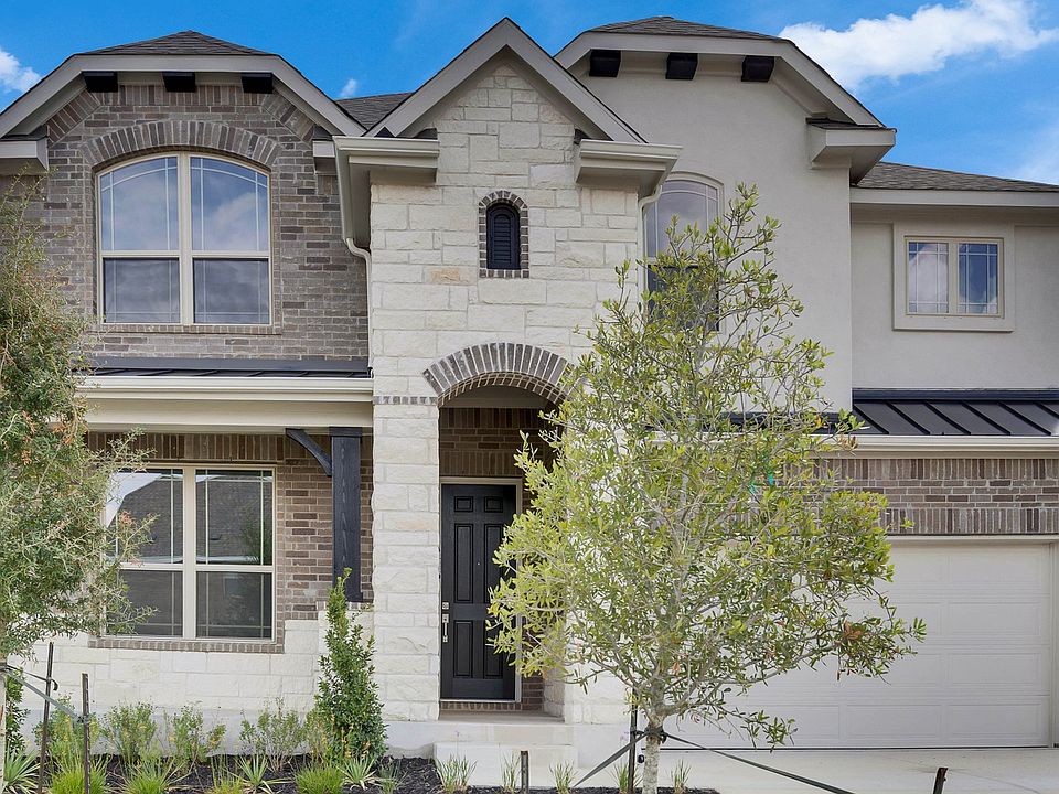 Elegant stone facade and arched entry define this Anthem home at 119 Douglass Way.