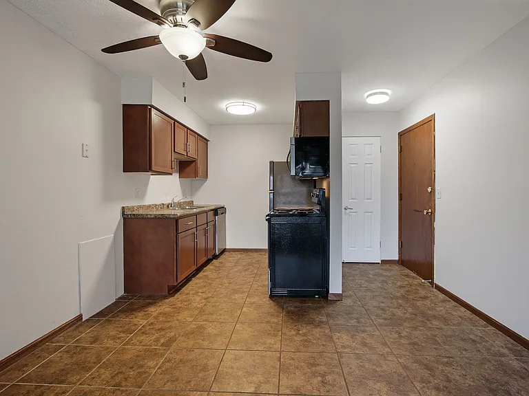Kitchen and dining room with ceiling fan