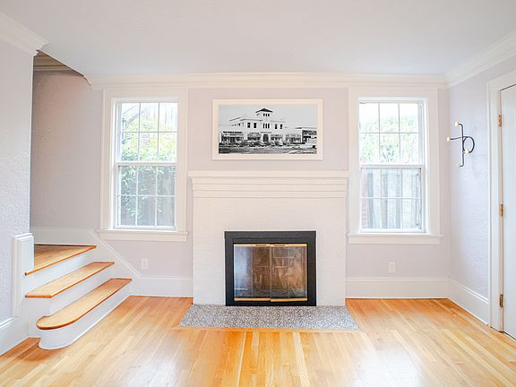 Living room with fireplace and stairs to second level