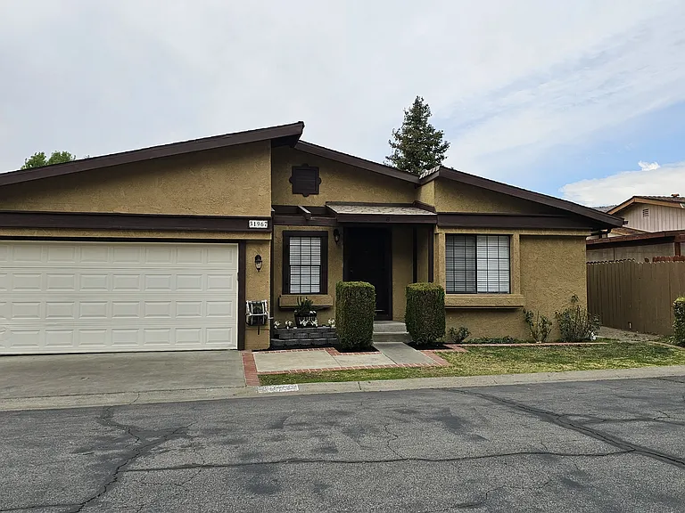Front of home with driveway and two car garage
