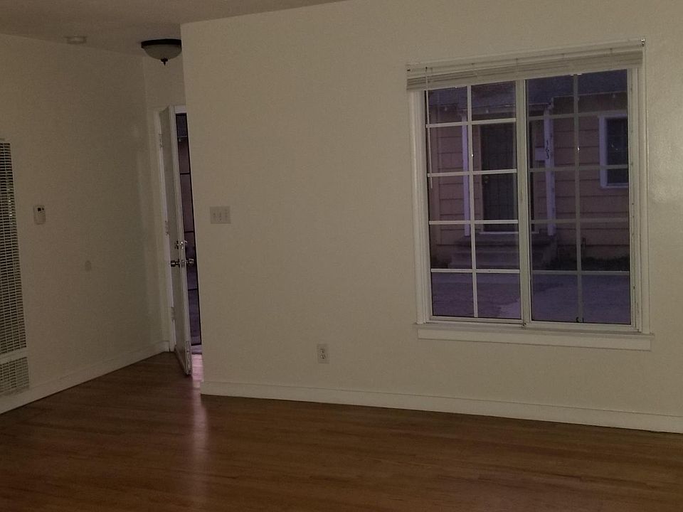 Living area and front door entry with linen closet