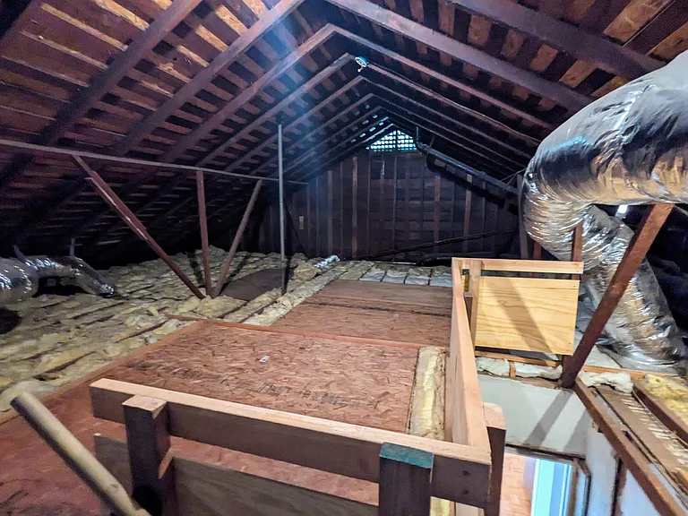 Large attic with plenty of storage space and wide permanent access stairs
