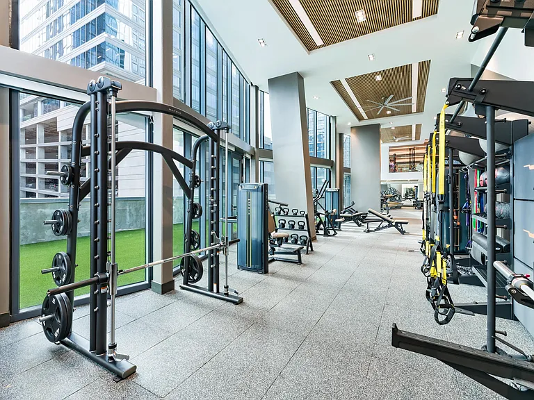 A light-filled fitness studio at Modera McGavock, offering expansive training space and city views.