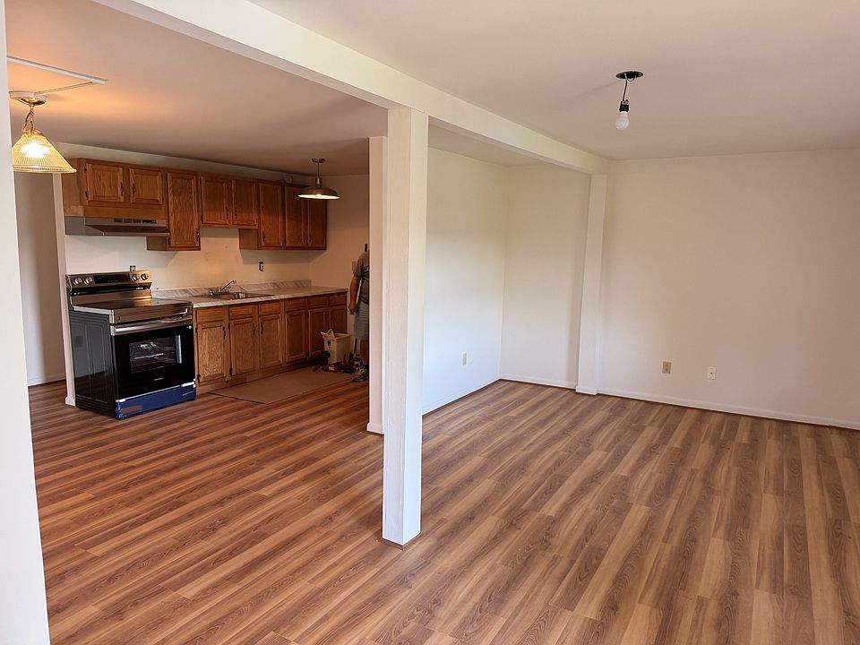 Large open concept area Living room, Kitchen, Dining room overlooking lake with brand new flooring, new appliances, countertops and backsplash.