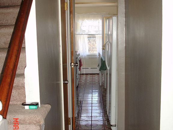 To Right of Stairs - Foyer Leading to Kitchen 