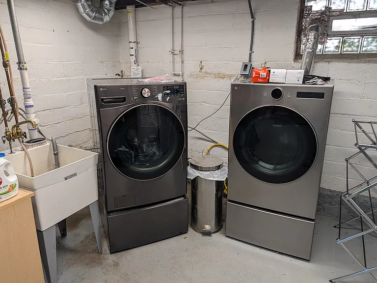 Southwest corner of basement new washer and dryer, no cost shared with upstairs 2nd floor tenants. There is storage space available on the east wall.