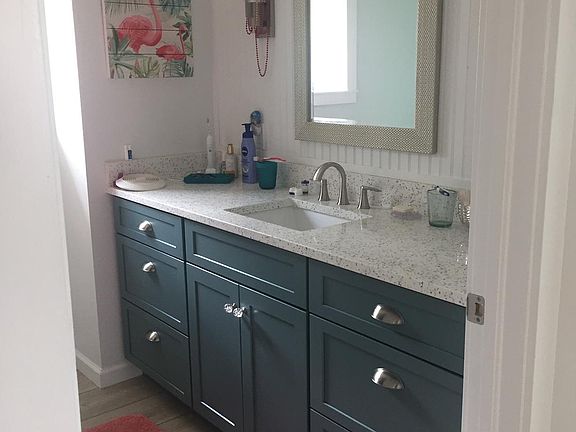 Bright and clean bathroom with tiled walk in shower.