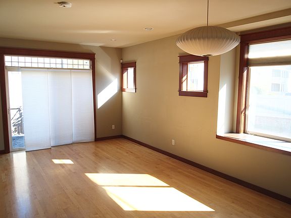 Afternoon sunshine floods the living room/dining room