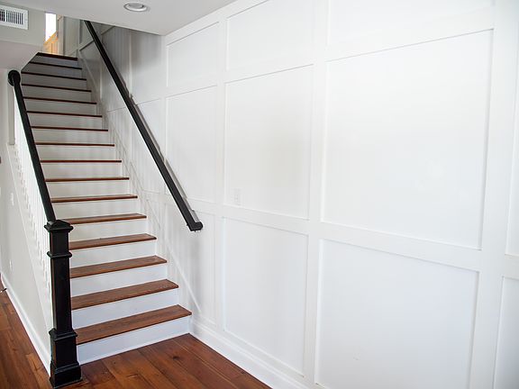 Charming Wainscoting in the entryway and up the stairs.