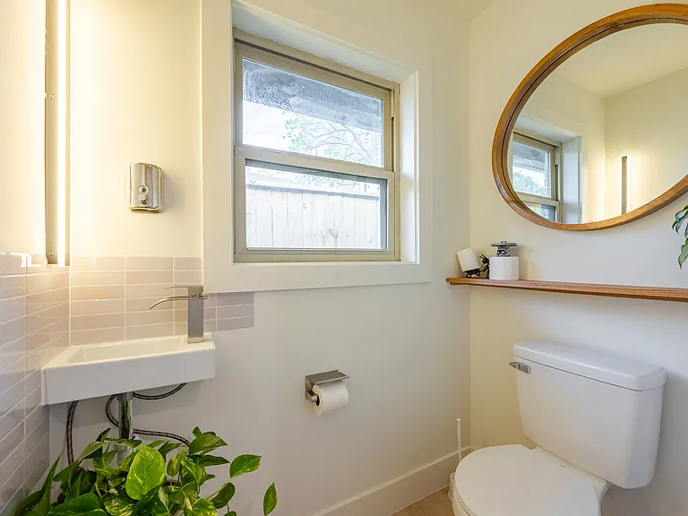 Conveniently located half bath just off the kitchen, featuring modern fixtures and natural light.