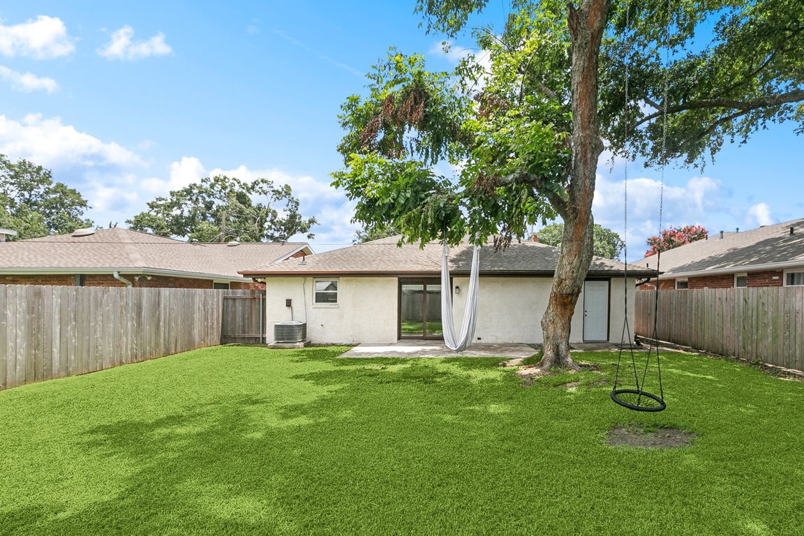 Large rear yard with patio and pecan tree