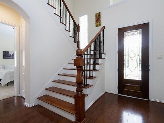 A warm and inviting entryway bellows with natural light that flows from the overhead windows into the 2-story entry!