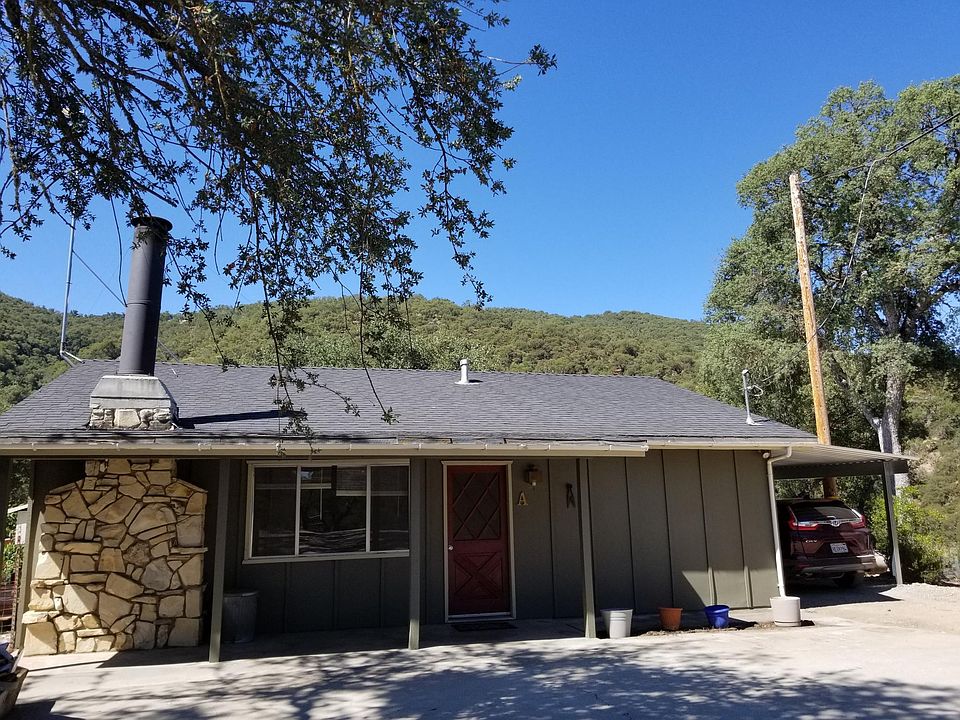 Front of house, carport to right