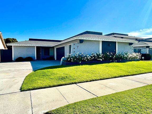 Beautifully remodeled home with only one attached wall. 2 Bedrooms 2 Bathrooms + 1 Car Garage & backyard with patio & grass