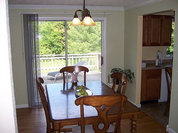 New modern light fixture in dining room leading to second story deck
