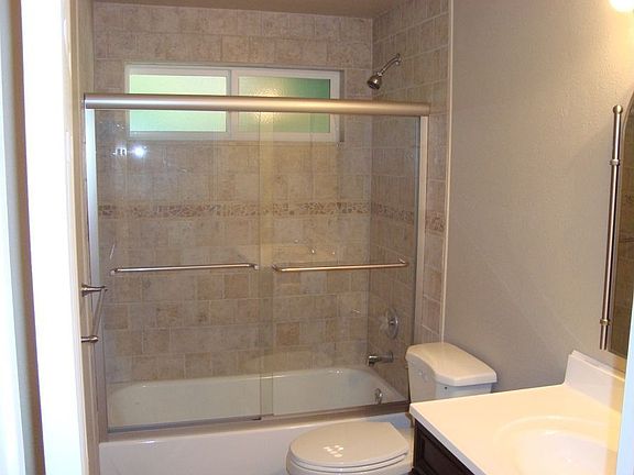 hall bath has tile shower & floor