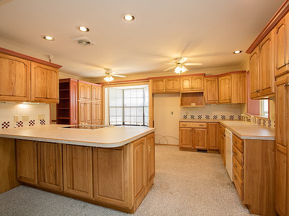 Easy to clean tile backsplash, recessed lighting and bay window with bench seat enhance the updated Kitchen. 