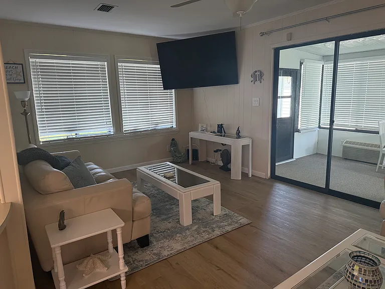 Living room opens to a furnished patio