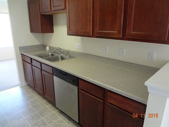 Kitchen w/ cherry cabintets and SS dishwasher
