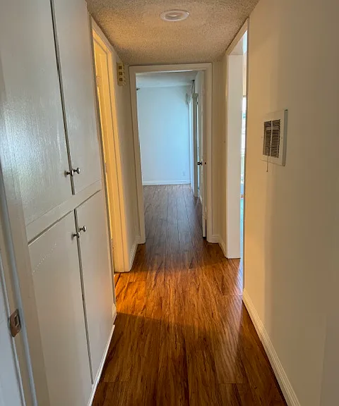 Hallway between two bedrooms has bathroom in the middle