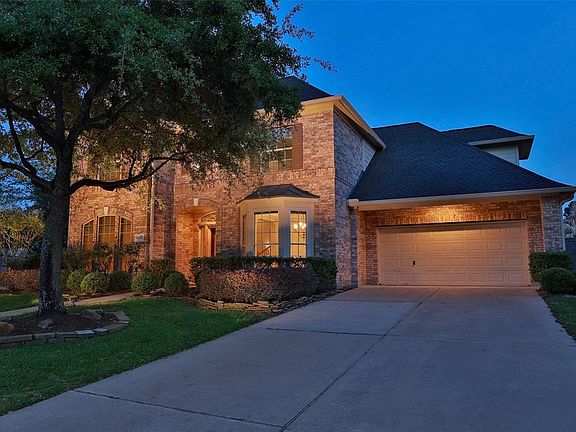 THREE CAR TANDEM GARAGE WITH DOUBLE WIDE DRIVEWAY