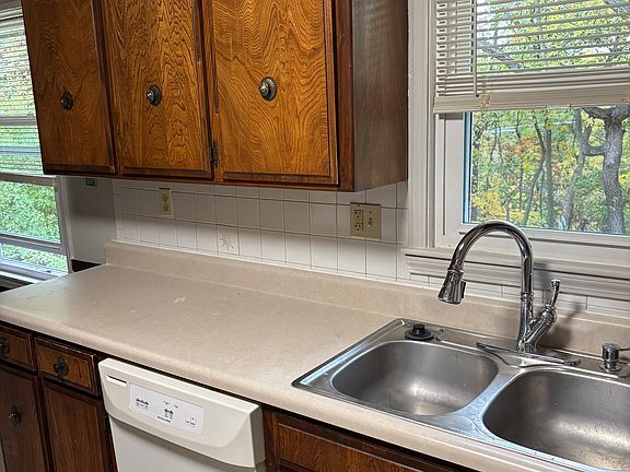 Kitchen sink, dishwasher and plenty of sunshine thru the multiple windows.
