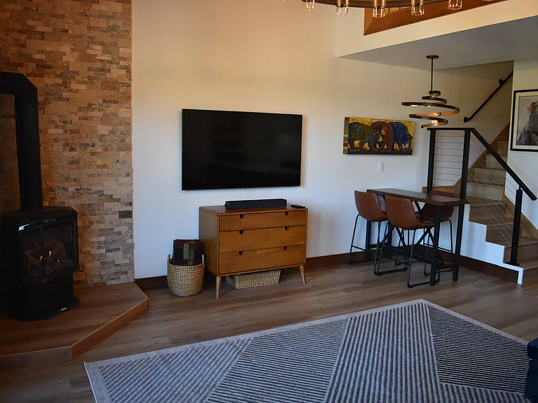 Gas fireplace, 60" wall-mounted TV and dining nook.