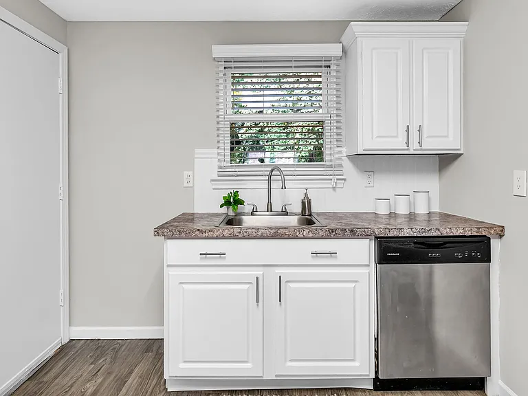 Immerse Yourself in the Beauty of White Cabinetry, Granite Touches, and Top-Notch Appliances in Our Modern Kitchens.