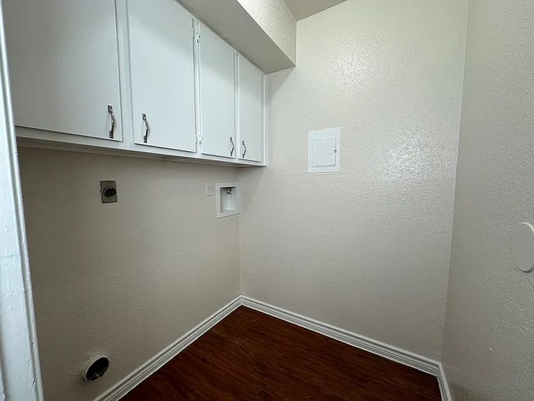 Cozy laundry nook with sleek white cabinets, ready for customization. Cozy laundry nook with sleek white cabinets, ready for customization.