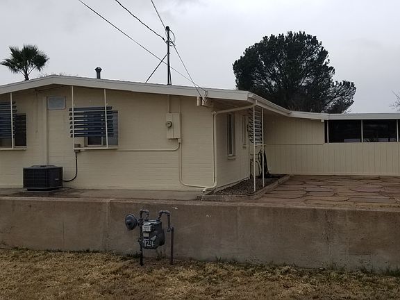 Back and side of house with new A/C and the side patio and swing