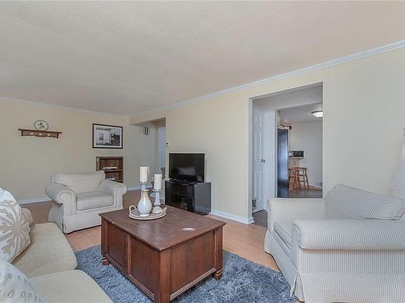 Crown molding accents this large living space which is ideal for family gatherings.