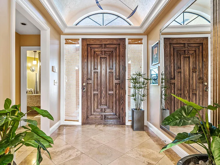 Foyer with travertine marble tiles.