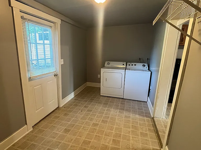 Laundry/storage room, rear entrance to the left.